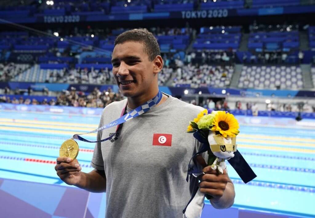 Jul 25, 2021; Tokyo, Japan; Ahmed Hafnaoui (TUN) celebrates with his gold medal during the medals ceremony for the men's 400m freestyle during the Tokyo 2020 Olympic Summer Games at Tokyo Aquatics Centre. Mandatory Credit: Rob Schumacher-USA TODAY Network