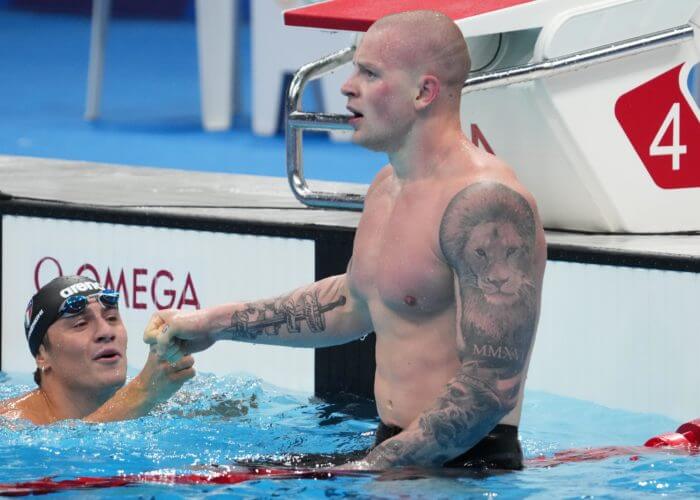 Jul 26, 2021; Tokyo, Japan; Adam Peaty (GBR) is congratulated by Nicolo Martinenghi (ITA) after seeing the results of the men's 100m breaststroke final during the Tokyo 2020 Olympic Summer Games at Tokyo Aquatics Centre. Mandatory Credit: Robert Hanashiro-USA TODAY Sports