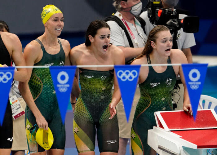 Aug 1, 2021; Tokyo, Japan; Kaylee McKeown (AUS), Chelsea Hodges (AUS) and Emma McKeon (AUS) celebrate their victory in the women's 4x100m medley final during the Tokyo 2020 Olympic Summer Games at Tokyo Aquatics Centre. Mandatory Credit: Rob Schumacher-USA TODAY Sports - Australia