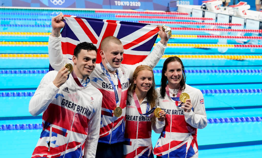Jul 31, 2021; Tokyo, Japan; Great Britain mixed 4x100m medley relay team celebrate their gold medal during the Tokyo 2020 Olympic Summer Games at Tokyo Aquatics Centre. Mandatory Credit: Rob Schumacher-USA TODAY Sports Adam Peaty