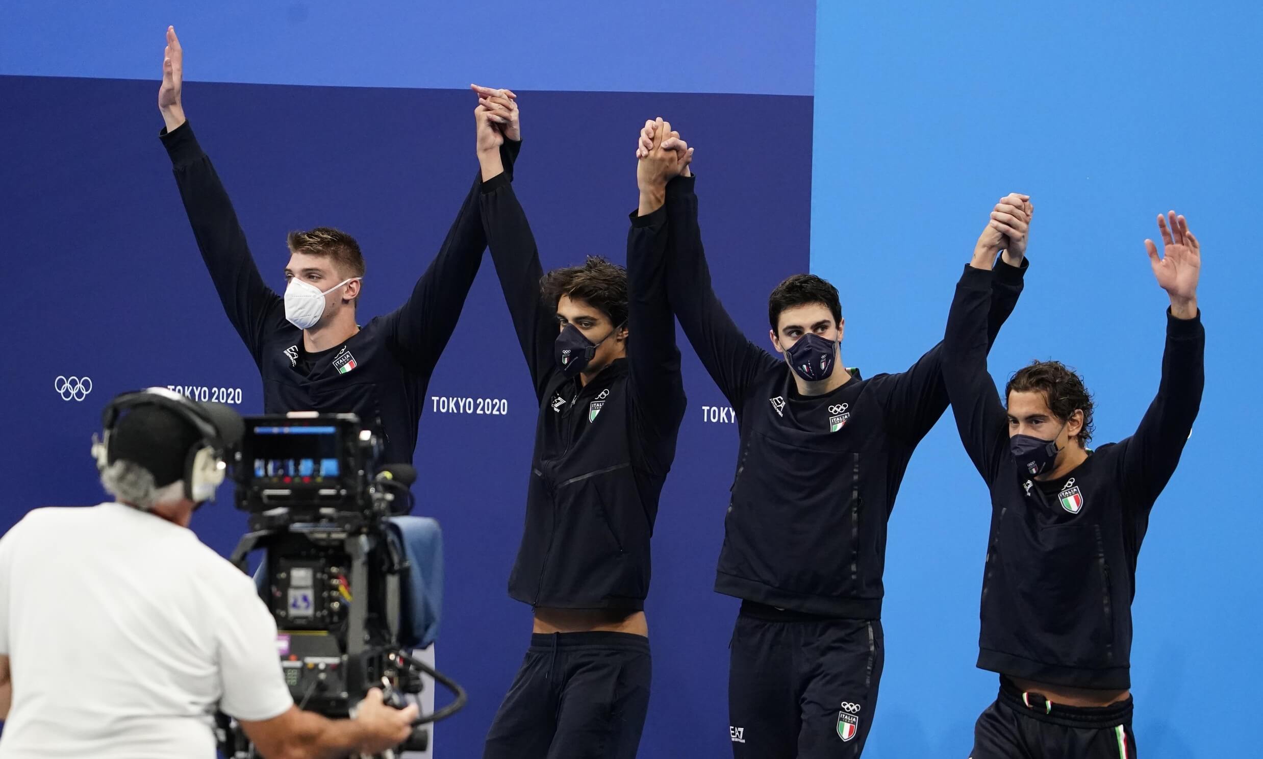 Jul 26, 2021; Tokyo, Japan; Italy relay team celebrates on the podium in the medals ceremony for the men's 4x100m freestyle relay during the Tokyo 2020 Olympic Summer Games at Tokyo Aquatics Centre. Mandatory Credit: Rob Schumacher-USA TODAY Sports