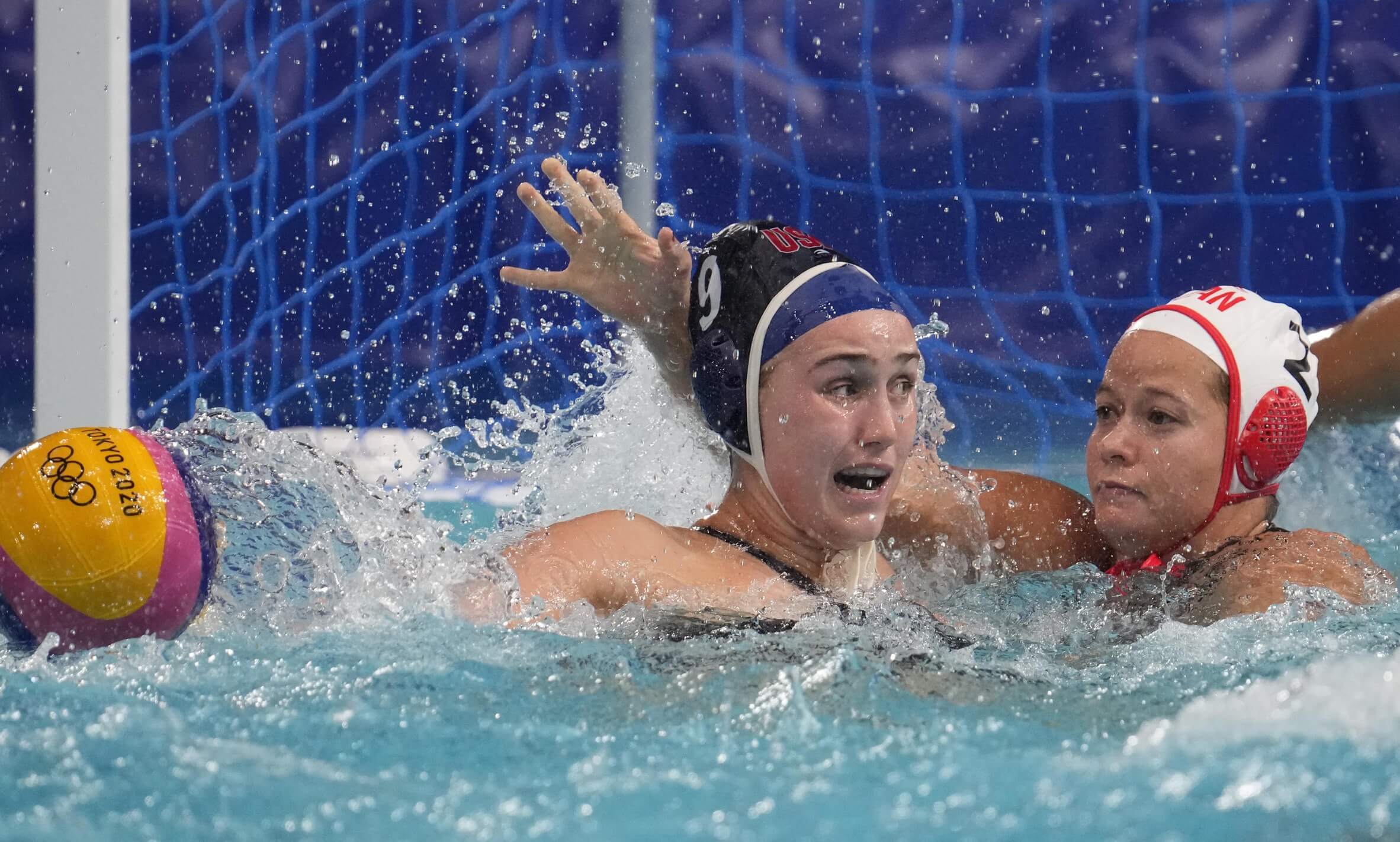Aug 3, 2021; Tokyo, Japan; Team United States centre forward Aria Fischer (9) and Team Canada centre back Kelly McKee (2) battle for the ball in a women's water polo quarter final match during the Tokyo 2020 Olympic Summer Games at Tatsumi Water Polo Centre. Mandatory Credit: Robert Hanashiro-USA TODAY Sports