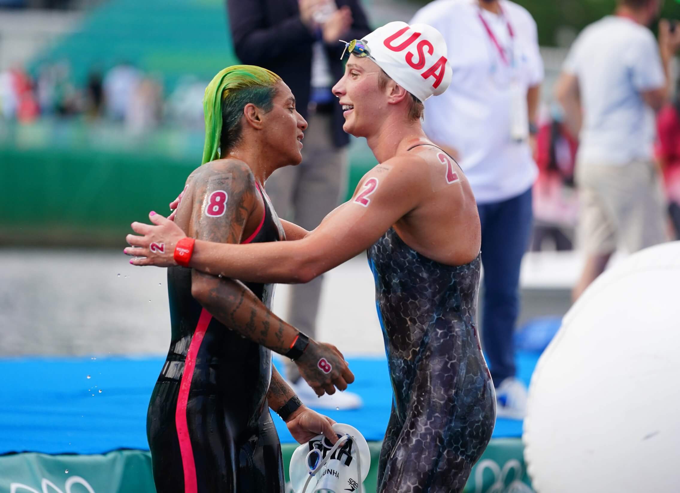 Aug 4, 2021; Tokyo, Japan; Gold medalist Ana Marcela Cunha (BRA) reacts with Ashley Twichell (USA) after winning the women's 10km open water swimming competition during the Tokyo 2020 Olympic Summer Games at Odaiba Marine Park. Mandatory Credit: Kareem Elgazzar-USA TODAY Sports