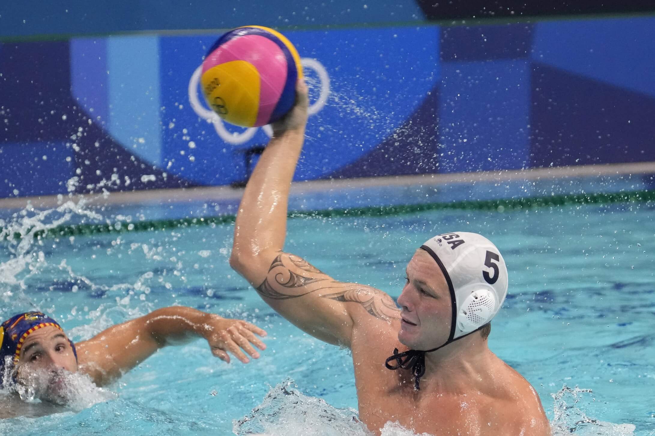 Aug 4, 2021; Tokyo, Japan; Team United States driver Hannes Daube (5) throws the ball against Spain in a men's water polo quarterfinal during the Tokyo 2020 Olympic Summer Games at Tatsumi Water Polo Centre. Mandatory Credit: Robert Hanashiro-USA TODAY Sports