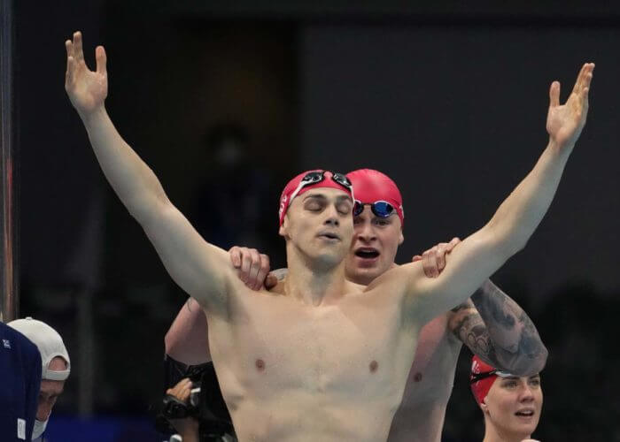 Jul 31, 2021; Tokyo, Japan; James Guy (GBR) and Adam Peaty (GBR) celebrate victory in the mixed 4x100m medley relay final during the Tokyo 2020 Olympic Summer Games at Tokyo Aquatics Centre. Mandatory Credit: Rob Schumacher-USA TODAY Sports