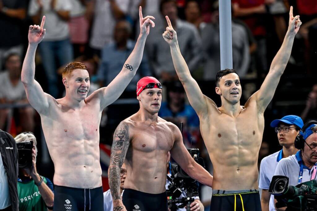 Tom Dean, Matthew Richards and James Guy of Great Britain celebrate after winning the gold medal in the swimming 4x200m Freestyle Men Final during the Paris 2024 Olympic Games at La Defense Arena in Paris (France), July 30, 2024.
