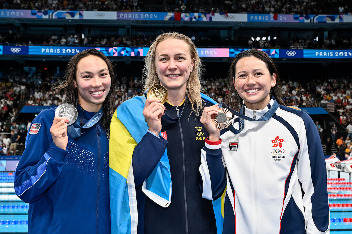 Torri Huske of United States of America, silver, Sarah Sjoestroem of Sweden, gold, Siobhan Bernadette Haughey of Hong Kong, bronze show the medals after competing in the swimming 100m Freestyle Women Final during the Paris 2024 Olympic Games at La Defense Arena in Paris (France), July 31, 2024.