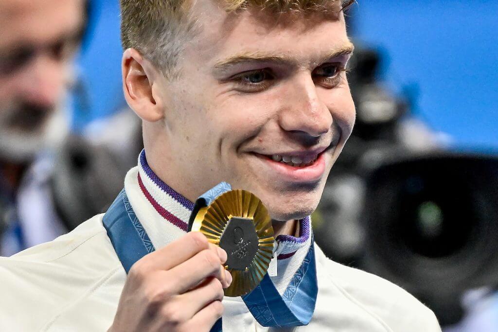 Leon Marchand of France shows the gold medal after competing in the Men's 400m Individual Medley final during the Paris 2024 Olympic Games at La Defense Arena in Paris (France), July 28, 2024.