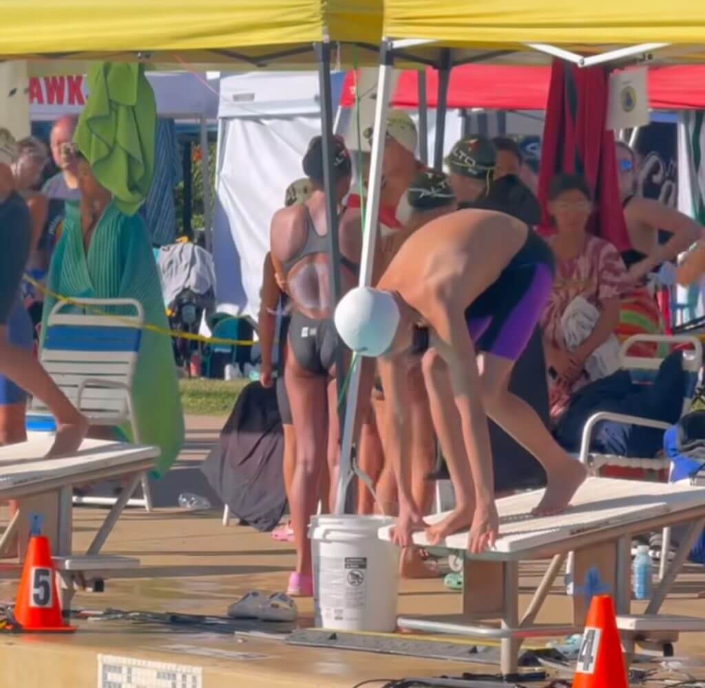 Ayden Tan prepares to race the 50 free, focused on the finals at Far Westerns.