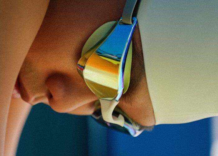 Competitive swimmer wearing Maritonia Hydroclear swim goggles.