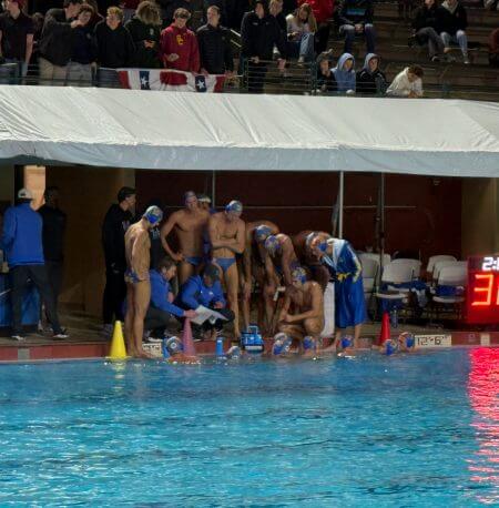 UCLA Coach Adam Wright draws up strategy against Stanford